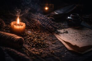 An abstract, tactile still-life of ritual materials in indigo shadow with warm gold highlights.